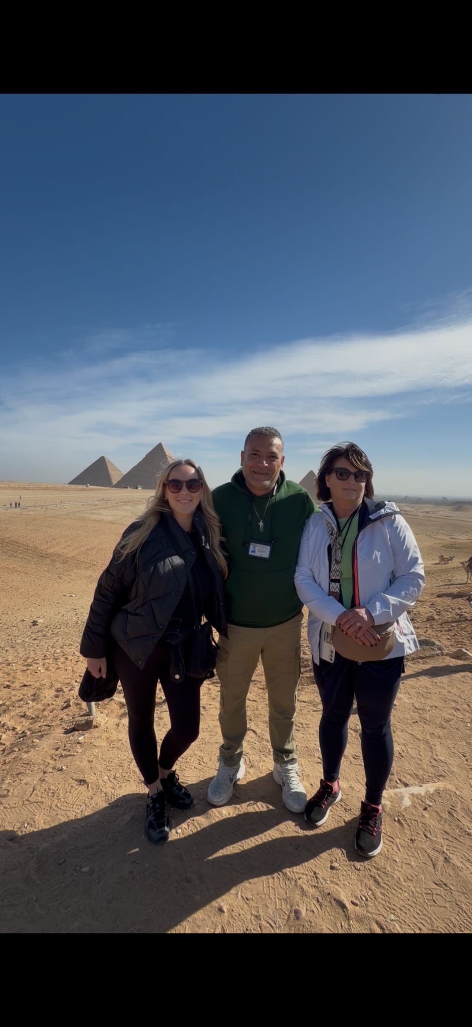 Tour guide with tourists at the Pyramids of Giza